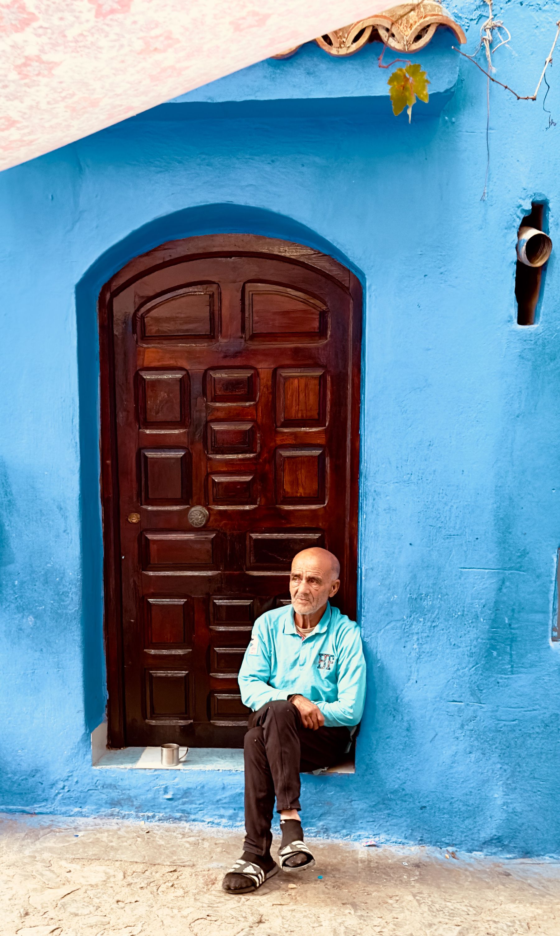 Old Man Sits on Door Steps